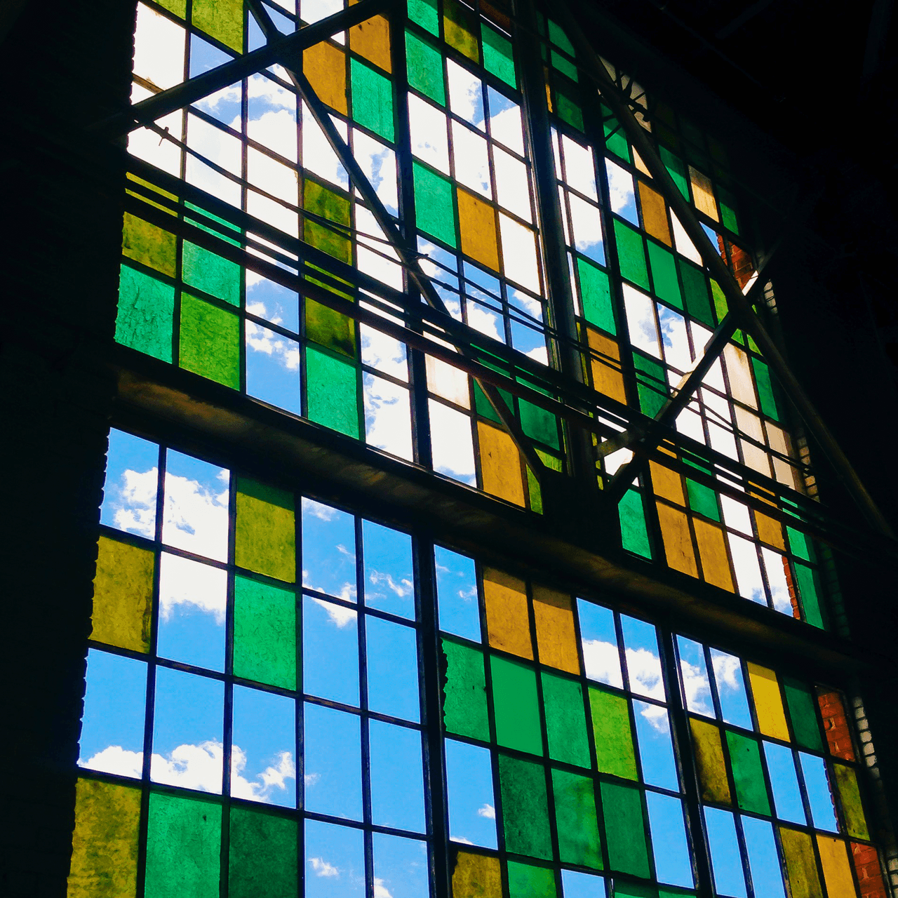 The interior of the Albuquerque Rail Yards locomotive shop, with light from the roof glazing.